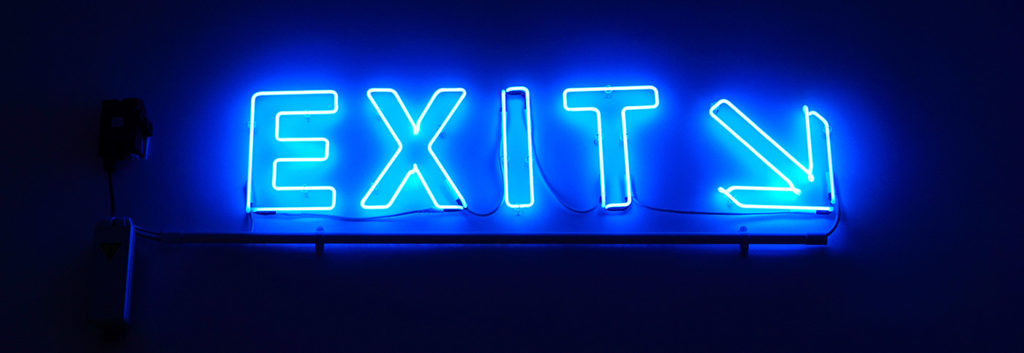 An exit sign with a pointing arrow
